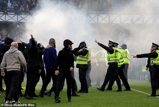 Police urge supporters to leave the field after shameful scenes at Ibrox