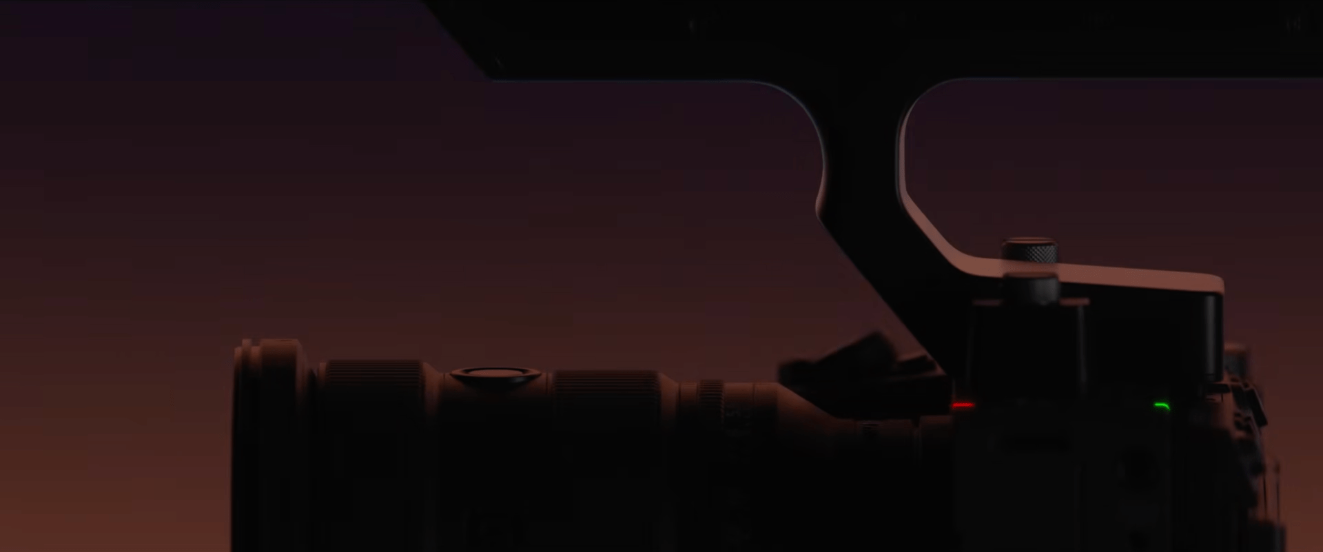The silhouette of a camera with a lens and top handle.