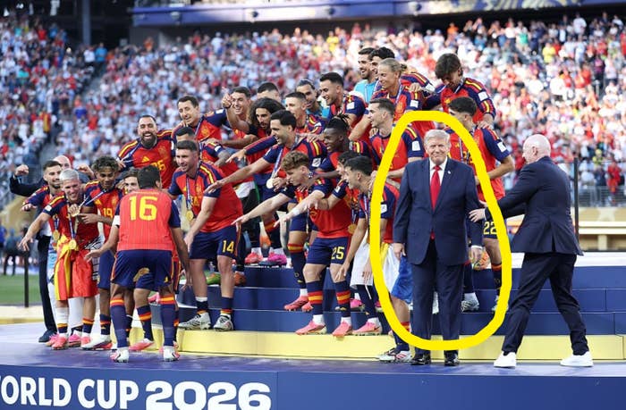 Spanish soccer team celebrating on stage with a trophy during the World Cup 2026 ceremony; Donald Trump standing next to them