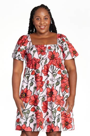 Person smiling in a floral-patterned dress with puff sleeves, suitable for casual occasions