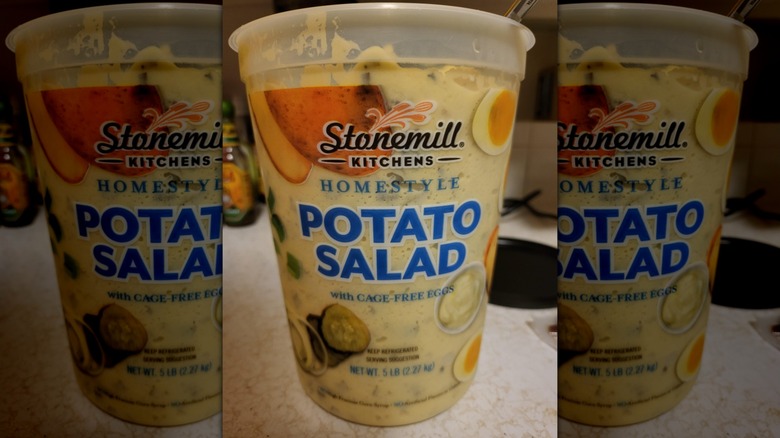 A container of Stonemill Kitchens Homestyle Potato Salad sits on a counter