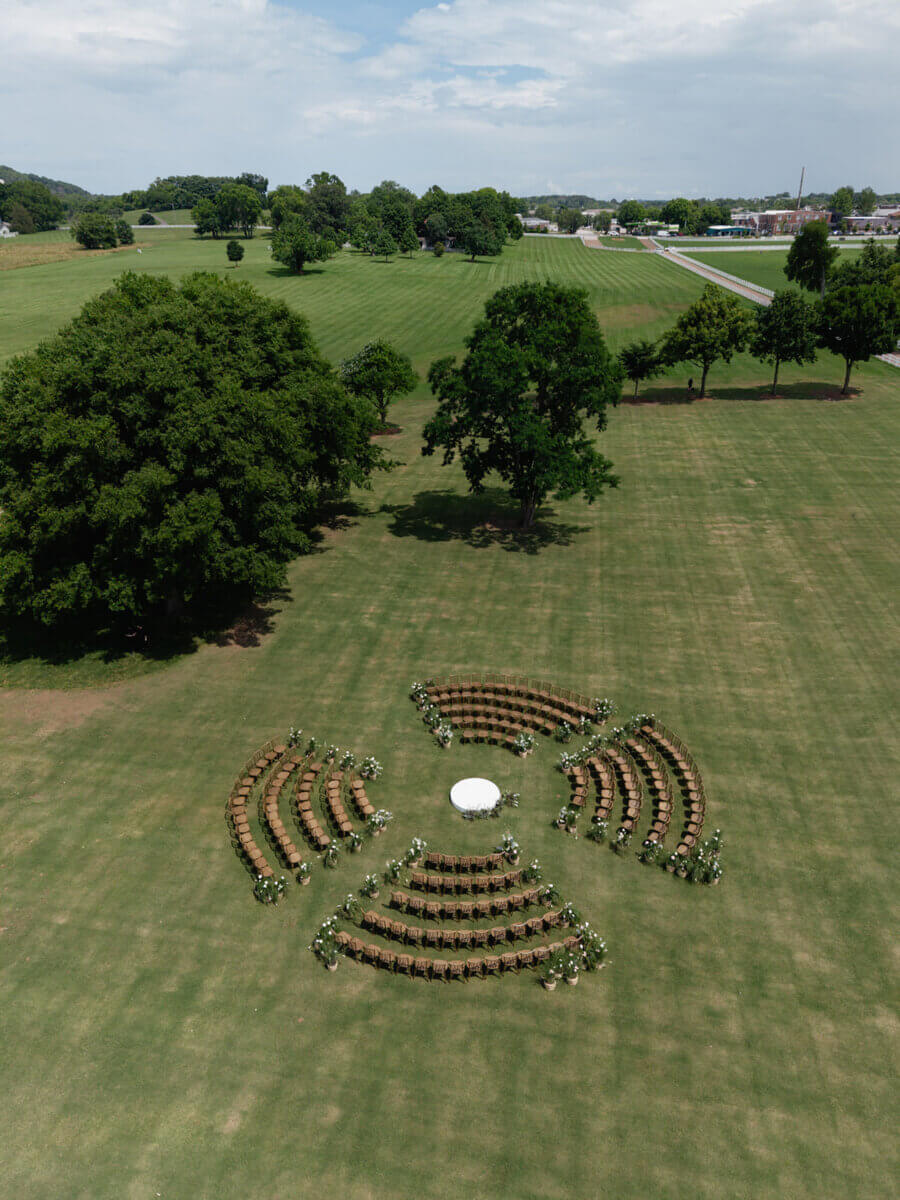 The ceremony was arranged in a circle around a raised platform so the couple could be completely surrounded by their loved ones. Image: Rachel Fugate Photography