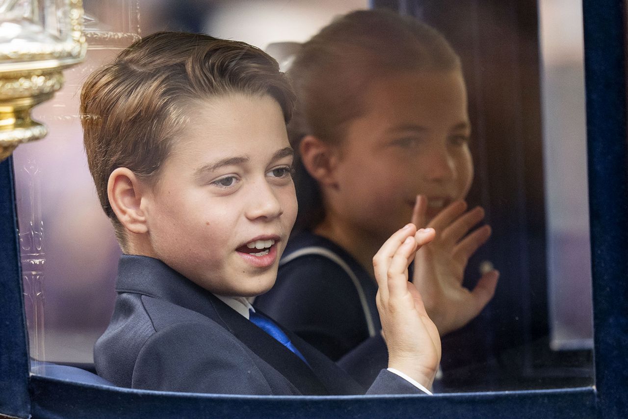 Prince George of Wales and Princess Charlotte of Wales wave during Trooping the Colour on June 15, 2024