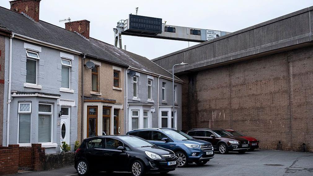 The imposing concrete embankments of the M4 dominate some cul-de-sac streets in Port Talbot where the motorway cut roads in two