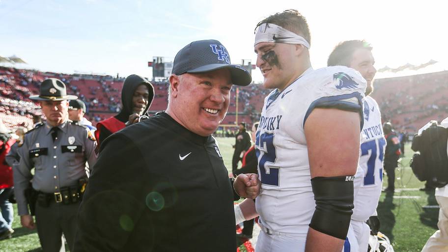 Kentucky Wildcats head coach Mark Stoops smiles with offensive lineman Jager Burton after a win over Louisville.