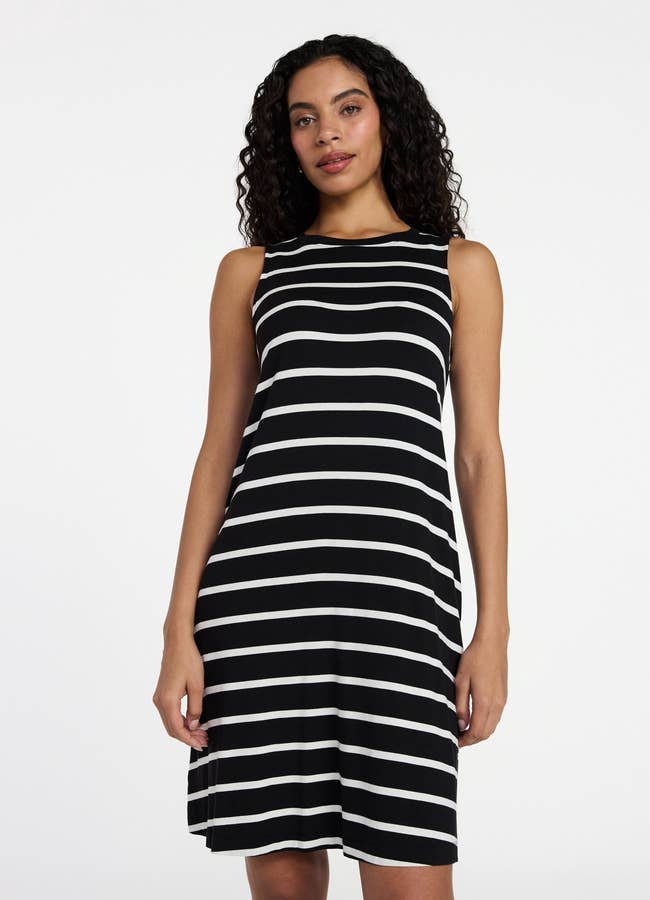 Person wearing a sleeveless striped dress, ideal for casual outings
