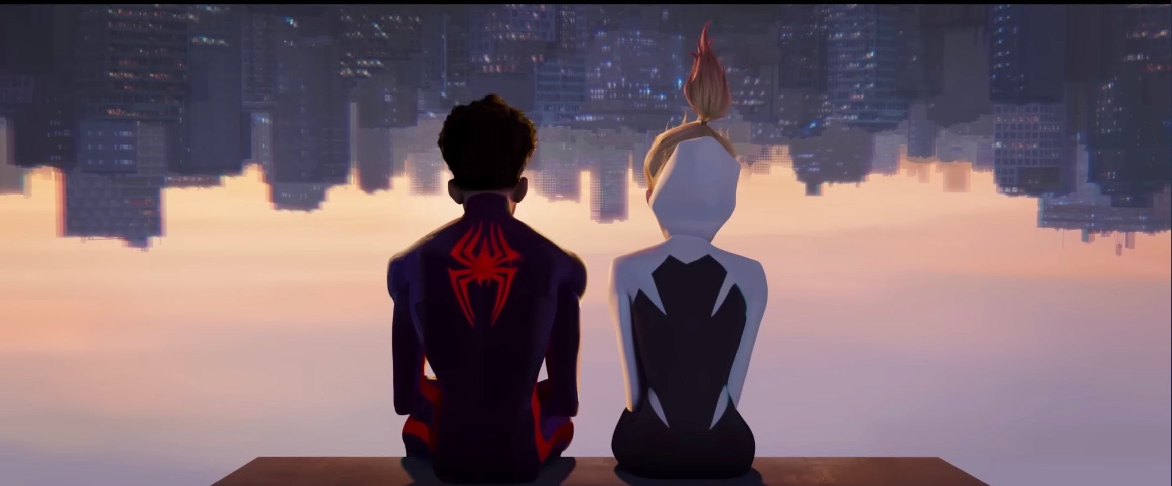 Miles and Gwen in “Spider-Man: Across the Spider-Verse” sit side by side on a rooftop overlooking an upside-down city skyline
