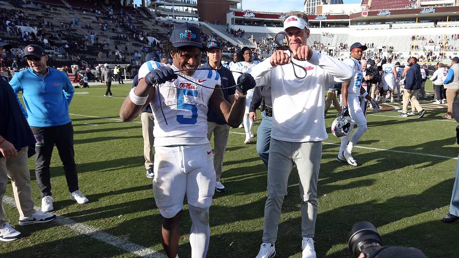 Mississippi Rebels running back Kewan Lacy (5) and head coach Lane Kiffin celebrate