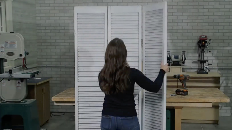 Person folding DIY privacy screen
