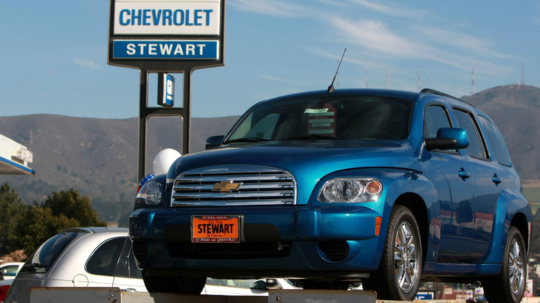 A then-new blue Chevrolet HHR parked outside of a Chevrolet dealer