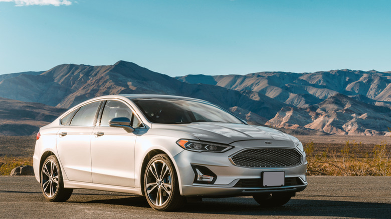 A silver 2018 Ford Fusion pictured against mountain backdrop