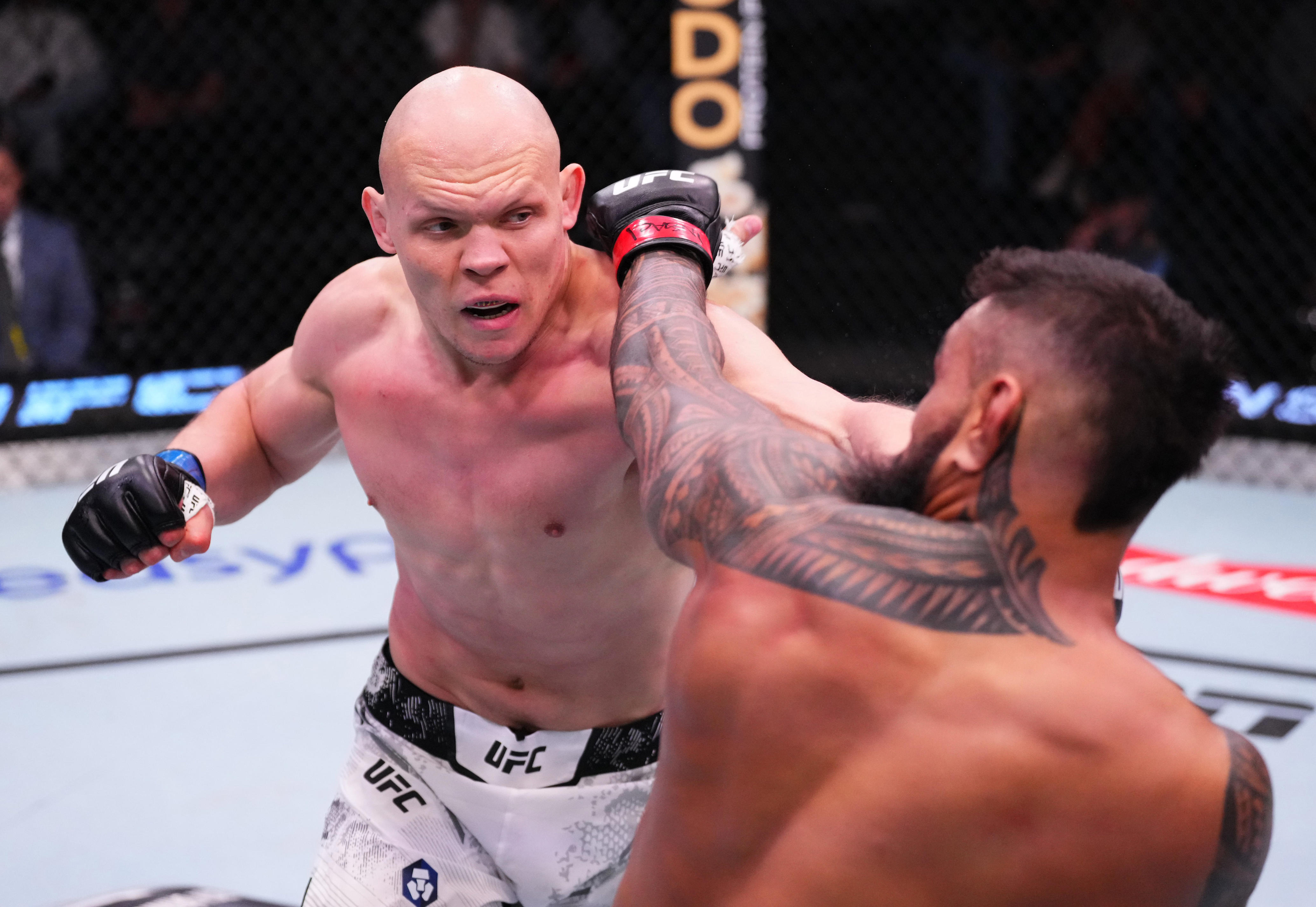 LAS VEGAS, NEVADA - FEBRUARY 10: (L-R) Bogdan Guskov of Uzbekistan punches Zac Pauga in a light heavyweight fight during the UFC Fight Night event at UFC APEX on February 10, 2024 in Las Vegas, Nevada. (Photo by Jeff Bottari/Zuffa LLC via Getty Images)