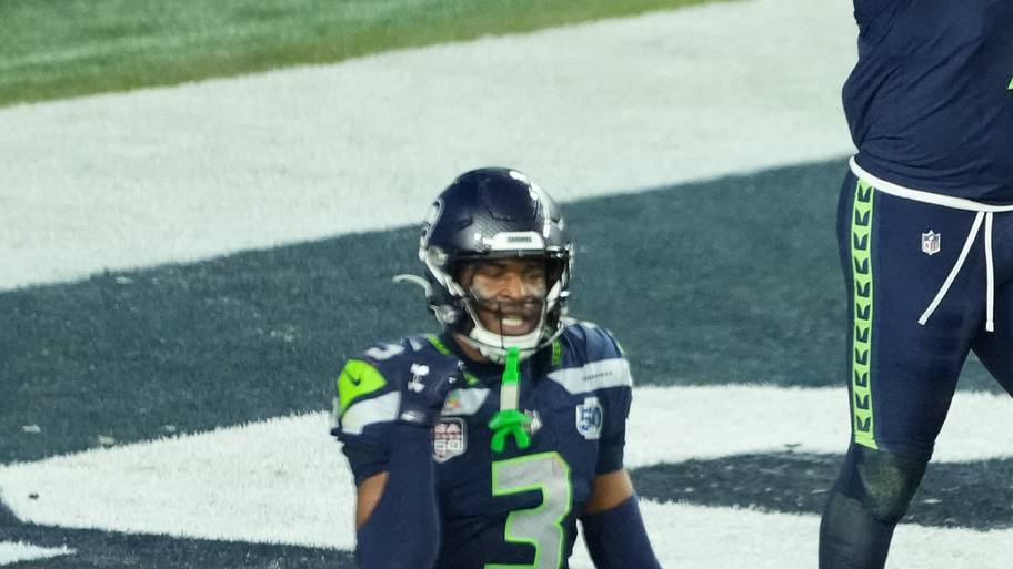 Seahawks EDGE Uchenna Nwosu celebrates after recovering a fumble and returning it for a touchdown against the Patriots.