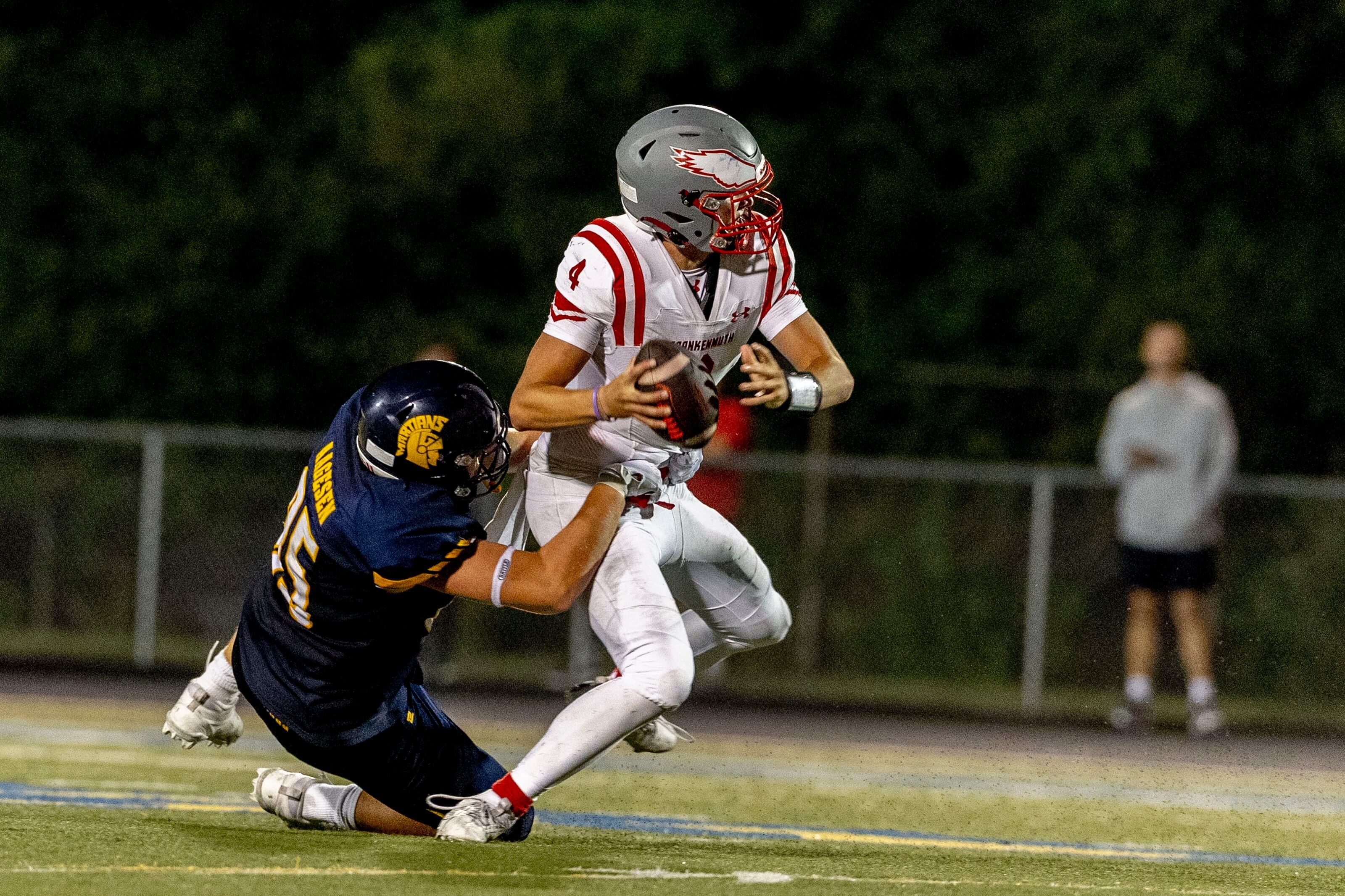 Goodrich offensive lineman Drew Aagesen (85) nearly sacks Frankenmuth senior quarterback Lleyton Hoard (4) during the season-opening game on Thursday, Aug. 28, 2025 at Goodrich High School. Goodrich defeated Frankenmuth 17-14.