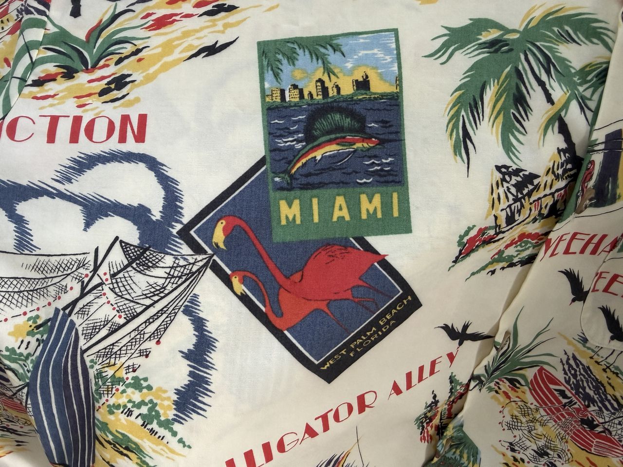 A fabric design featuring vintage Floridathemed imagery including a Miami label flamingos and tropical motifs