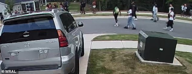 Video captured on a neighbor's Ring camera also showed a large group of teenagers walking in the middle of the street through one of the North Carolina communities