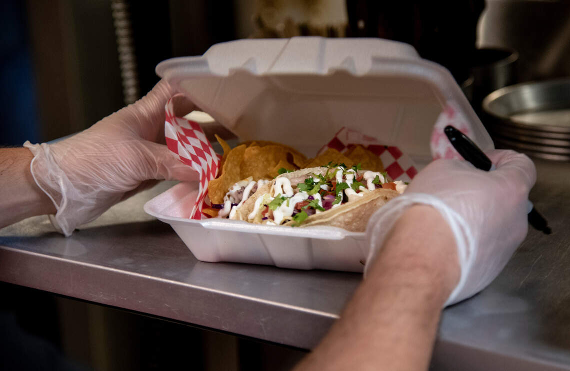 The fish tacos are topped with a red pepper slaw, chipotle aioli, fresh cilantro and more, according to the menu.