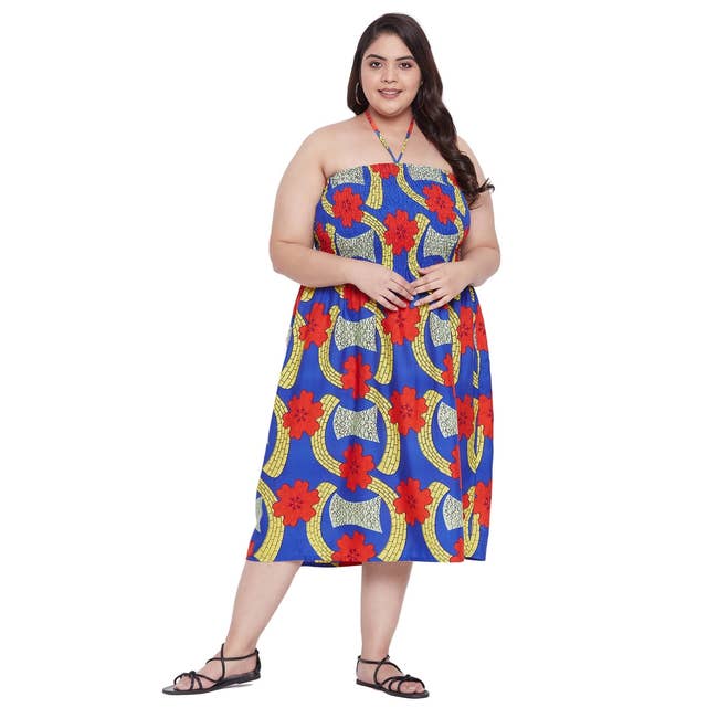 Person wearing a strapless dress with bold floral patterns, posing confidently, suitable for summer fashion shopping article