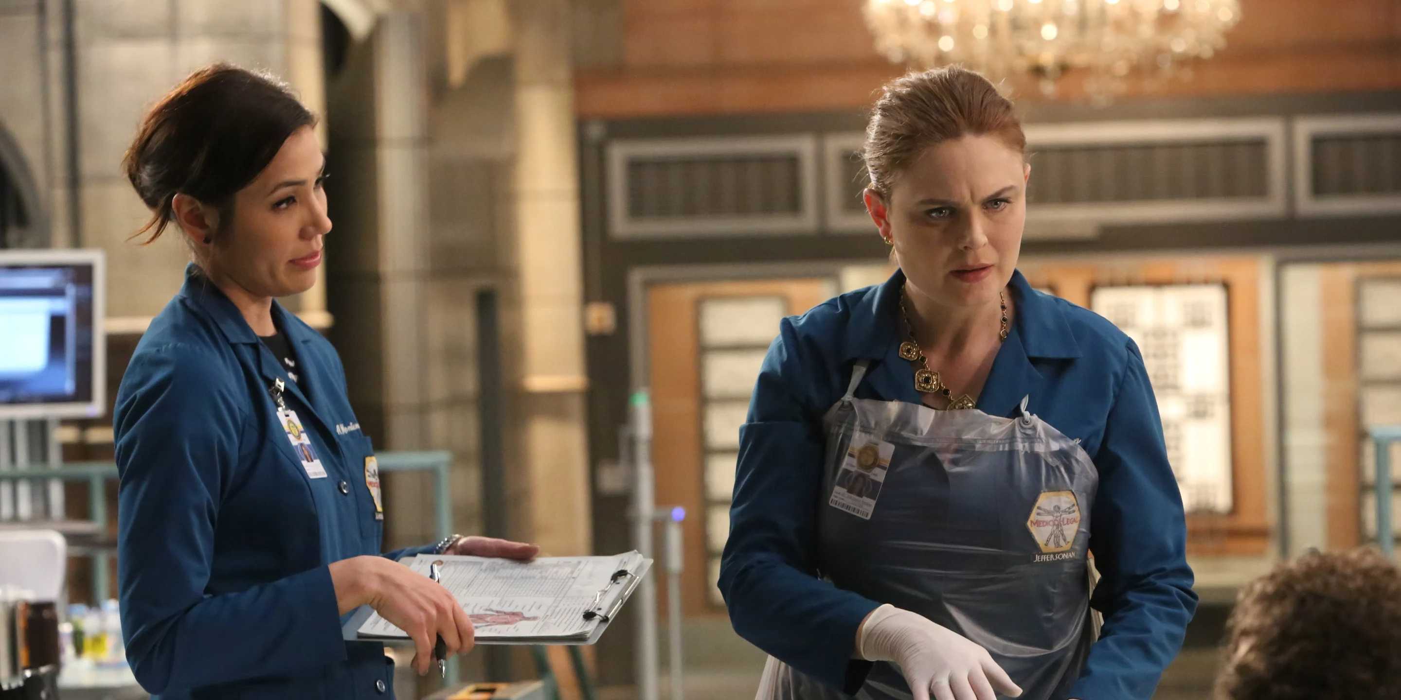 Bones looks annoyed while examing a body with her assistant