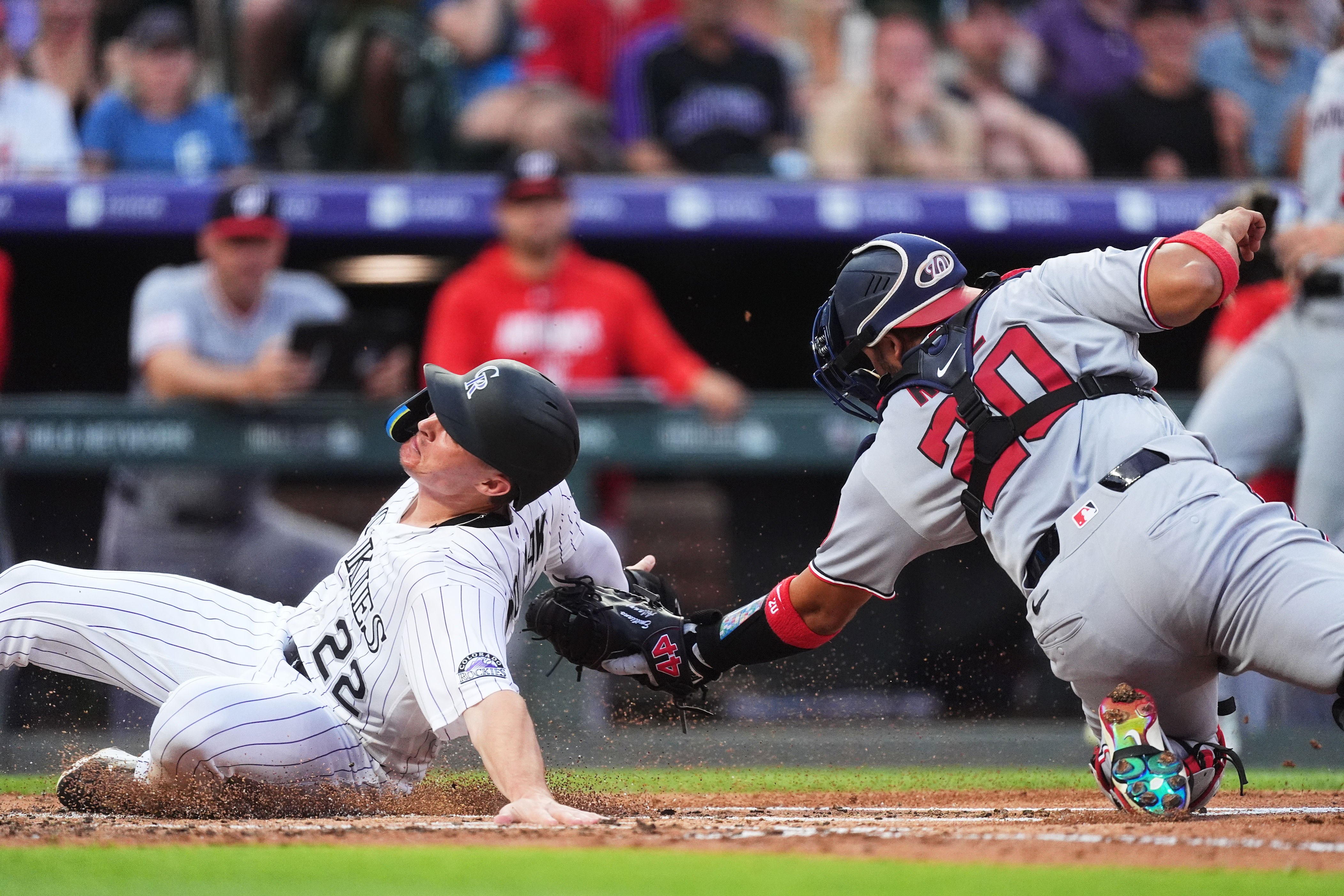 Washington Nationals catcher Keibert Ruiz, right, applies a late tag as Colorado Rockies' Mickey Moniak scores on a double hit by Jake McCarthy in the second inning of a baseball game Tuesday, July 21, 2026, in Denver. (AP Photo/David Zalubowski)