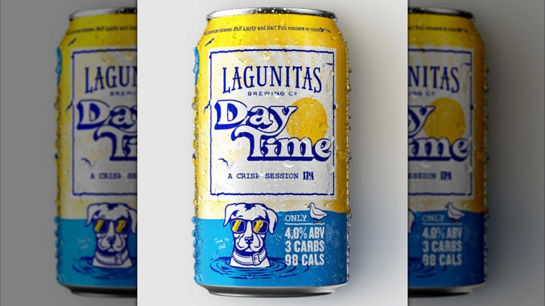 Two hands toasting with a glass and bottle of Lagunitas DayTime IPA