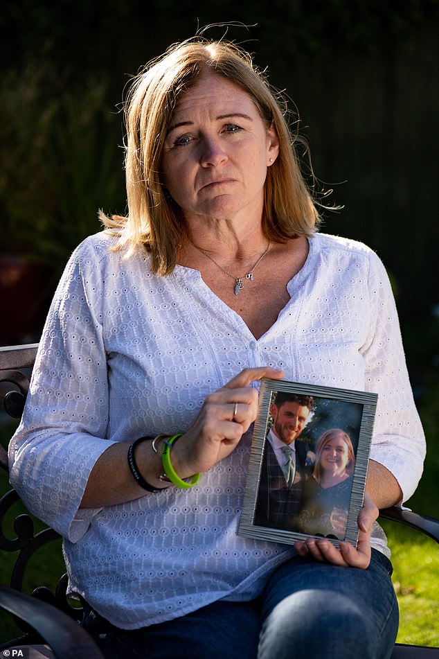 Deborah Adlam holding a photograph of her late son