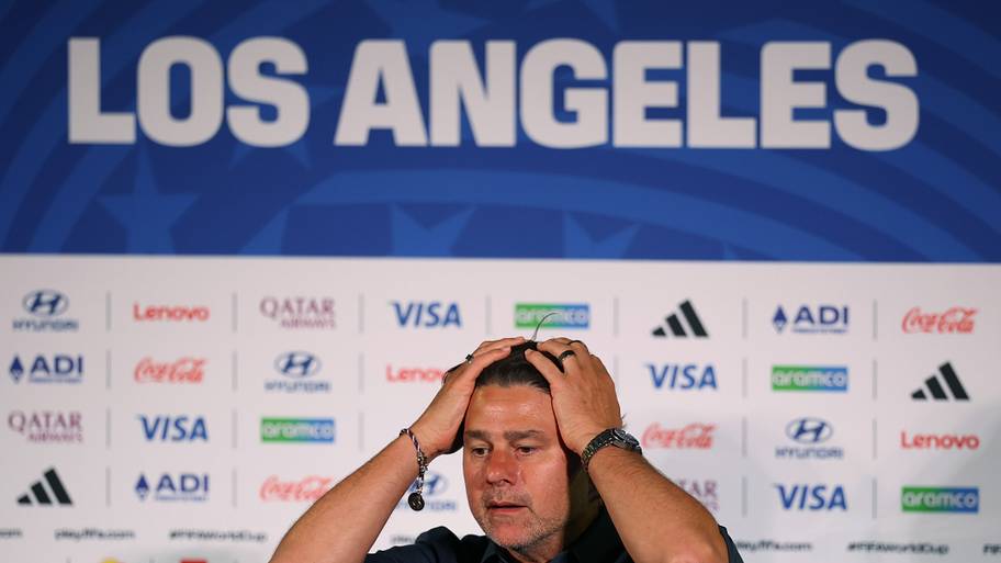 Mauricio Pochettino running his hands through his long hair.