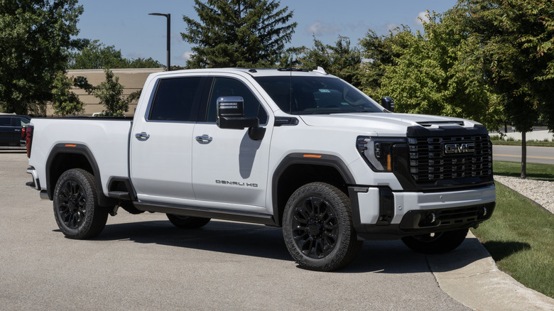 A white GMC Sierra 2500 4WD Denali Ultimate on display on a sunny day.