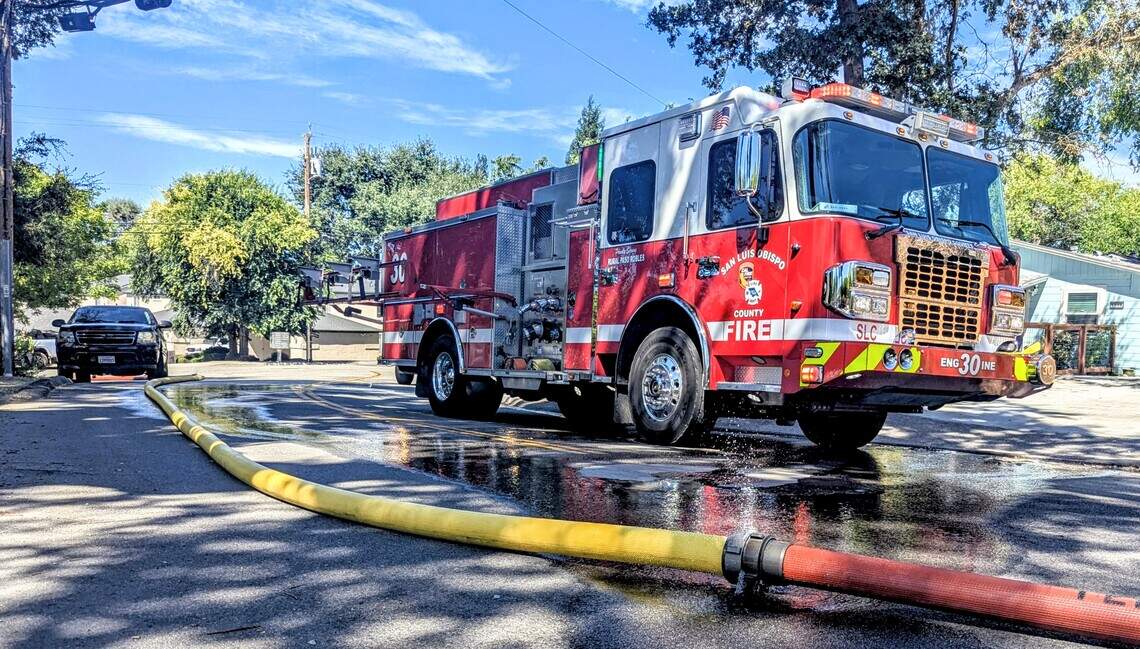 San Luis Obispo County Fire Engine 30 stands on Robles Avenue during the response to an attic fire at an Atascadero apartment complex Tuesday, July 21, 2026.