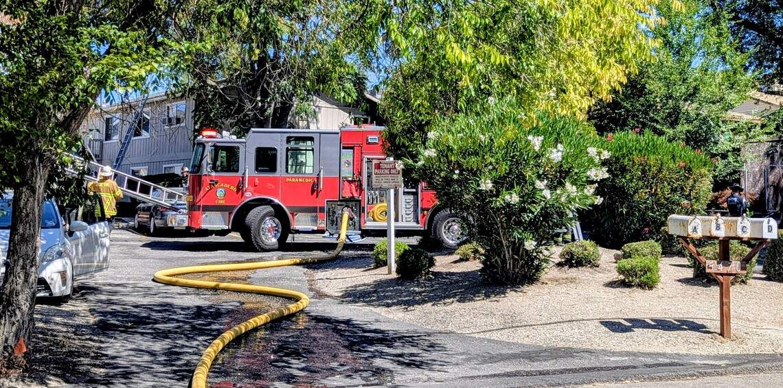 A firefighter readies a ladder as crews respond to an attic fire at an apartment complex at 5470 Robles Ave. in Atascadero on Tuesday, July 21, 2026. No injuries were reported.