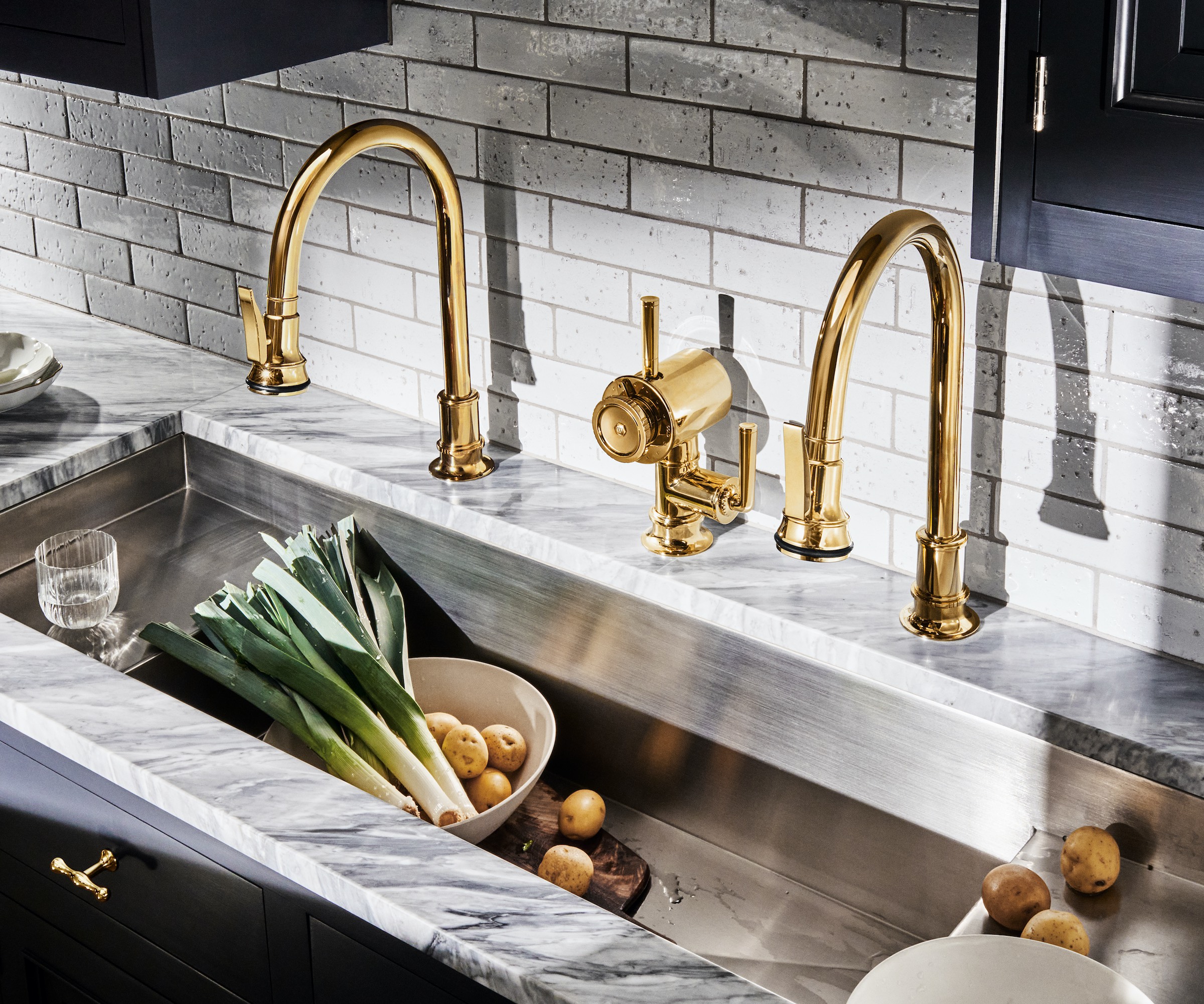 steel sink with two brass taps