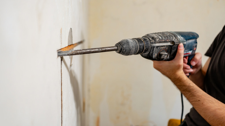 Close-up of worker holding Bosch rotary hammer drill