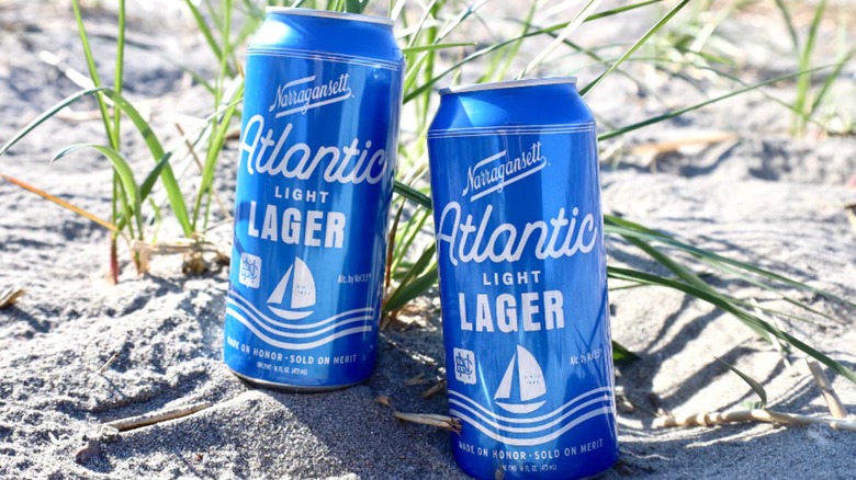 Hand pouring a can of Narragansett Atlantic Light Lager into a glass