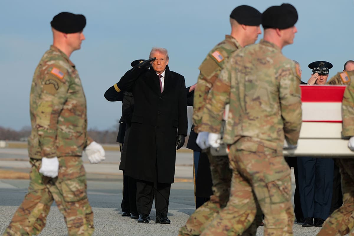 U.S. President Donald Trump salutes as a U.S. Army carry team moves a flagged-draped transfer case containing the remains of Iowa National Guardsman Sgt. William Nathaniel Howard at Dover Air Force Base on December 17, 2025 in Dover, Delaware. Iowa National Guard members Sgt. William Nathaniel Howard and Sgt. Edgar Brian Torres-Tovar and Ayad Mansoor Sakat, a U.S. civilian working as an interpreter, were killed during a recent ambush by an Islamic State (IS) gunman in Syria. (Photo by Anna Moneymaker/Getty Images)