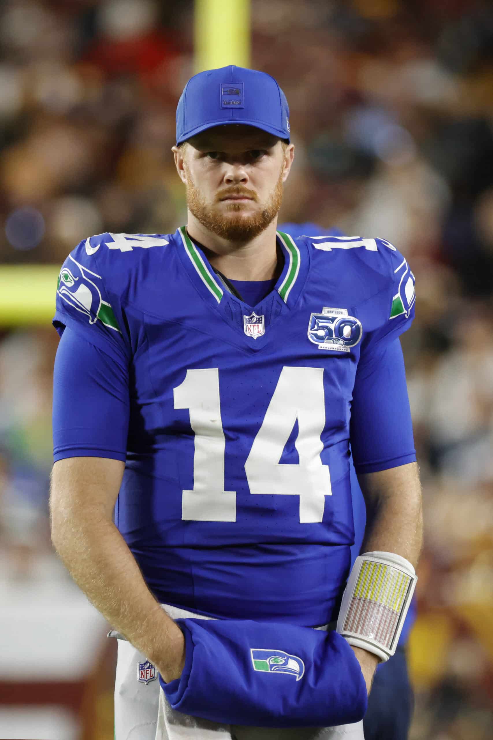Nov 2, 2025; Landover, Maryland, USA; Seattle Seahawks quarterback Sam Darnold (14) looks on from the field during the first half against the Washington Commanders at Northwest Stadium. Mandatory Credit: Amber Searls-Imagn Images