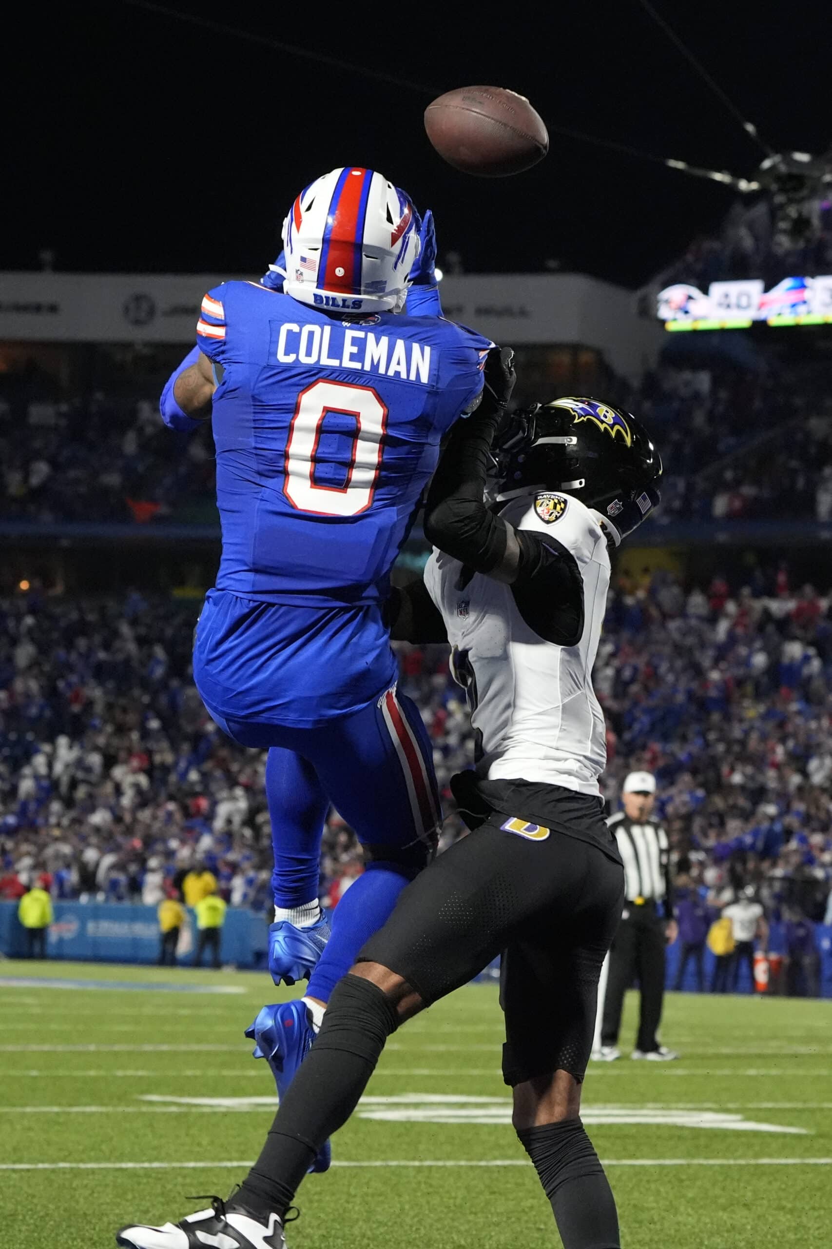 Sep 7, 2025; Orchard Park, New York, USA; Buffalo Bills wide receiver Keon Coleman (0) receives a ball against Baltimore Ravens cornerback Nate Wiggins (2) for a touchdown during the fourth quarter at Highmark Stadium. Mandatory Credit: Gregory Fisher-Imagn Images