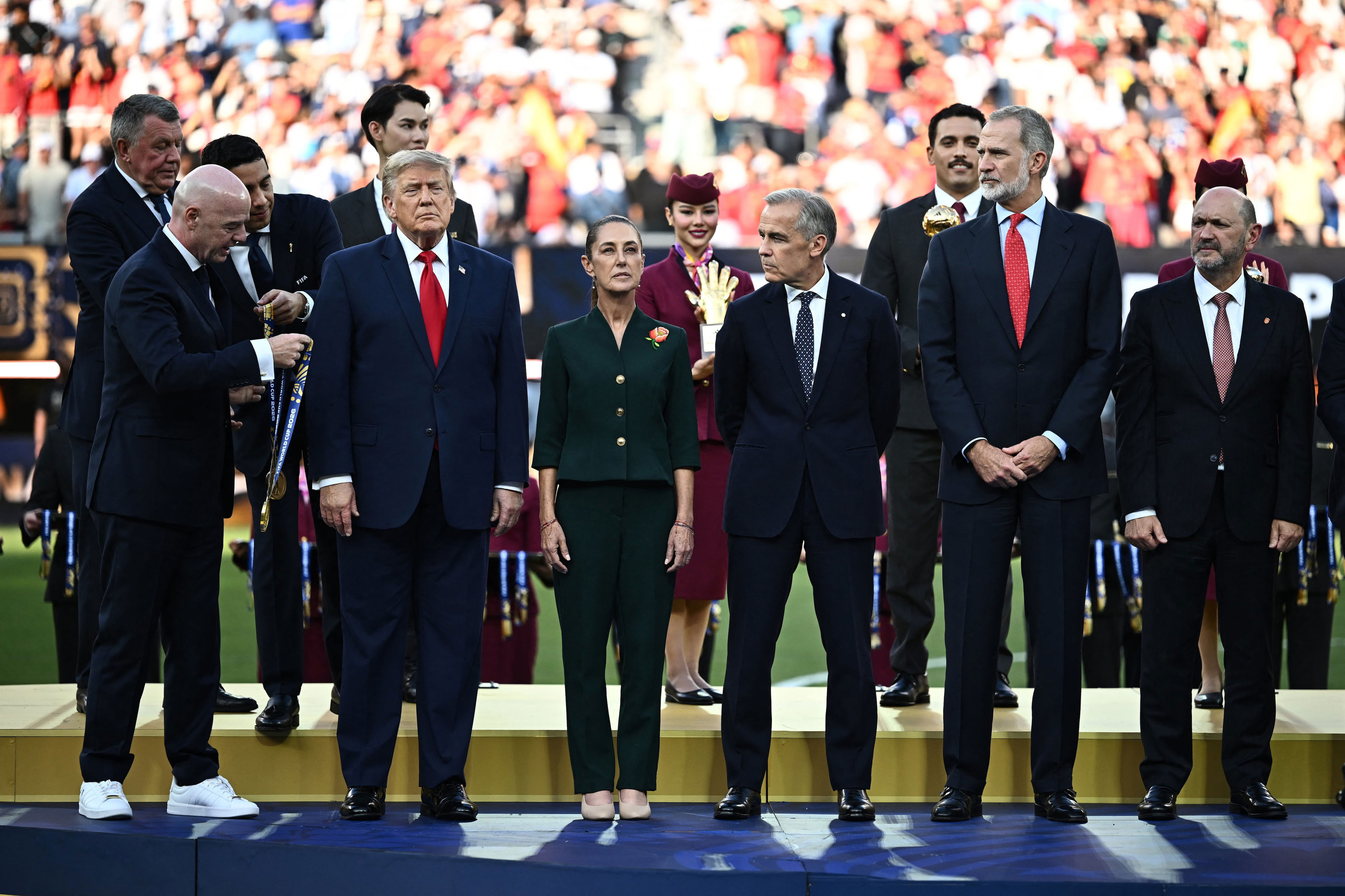 U.S. President Donald Trump, Mexican President Claudia Sheinbaum, Canada's Prime Minister Mark Carney, and FIFA President Gianni Infantino during the trophy presentation after the match. / Dylan Martinez / REUTERS