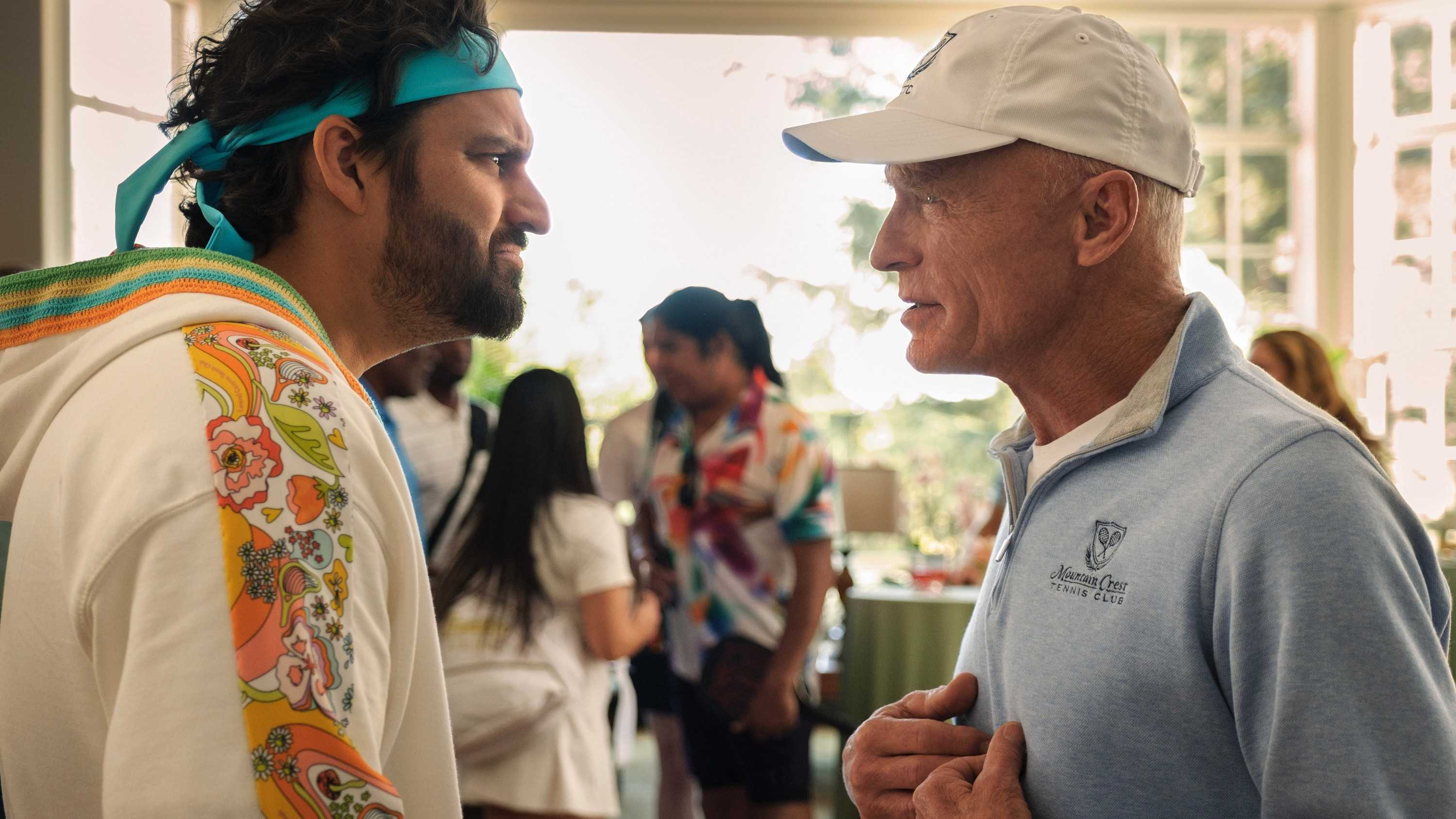 Jake Johnson and Ed Harris scowling at each other in The Dink