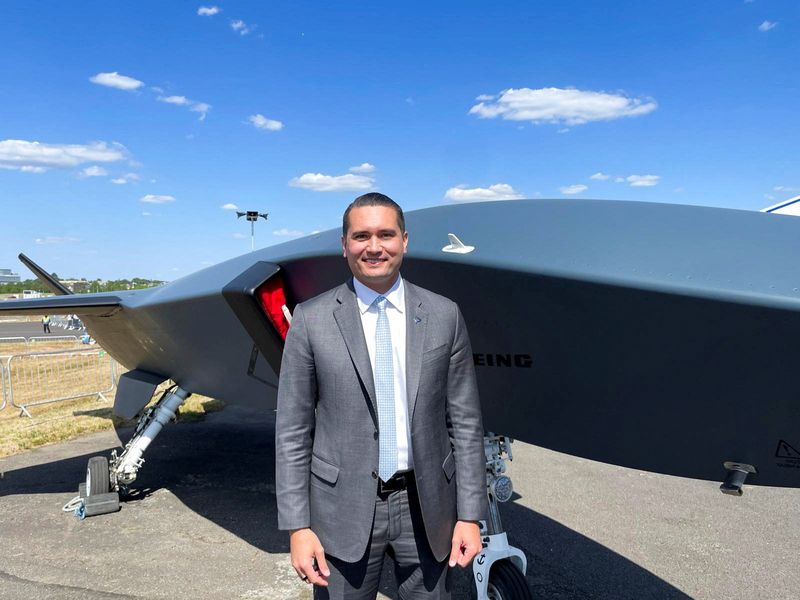 Bernd Peters, Boeing's vice president of business development and strategy, stands in front of the company's uncrewed combat aircraft called "Ghost Bat\