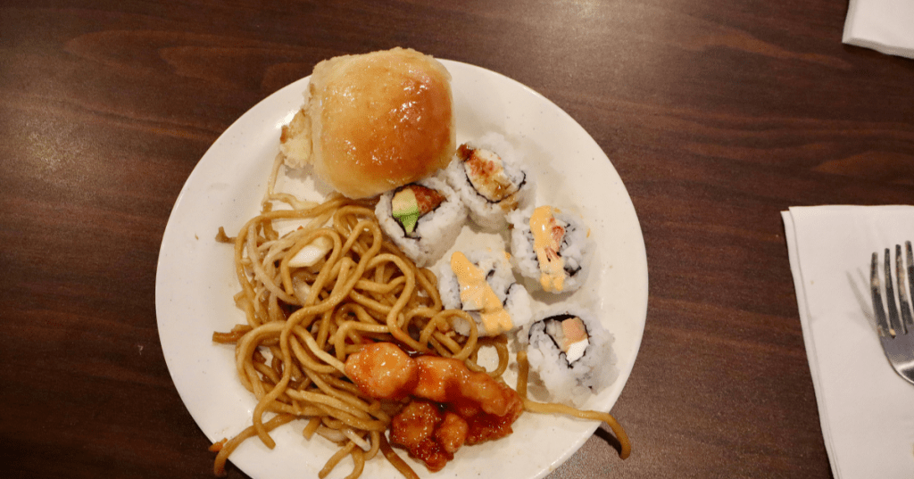 Buffet plate with lo mein noodles, sushi rolls, and chicken at Golden Palace Buffet, Livonia, MI.