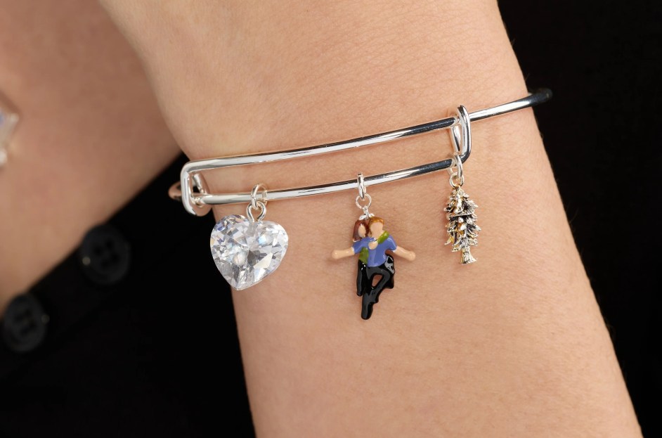 Alex and Ani Twilight bangle with Bella charm perched on Edward's back, a crystal heart and tree charm