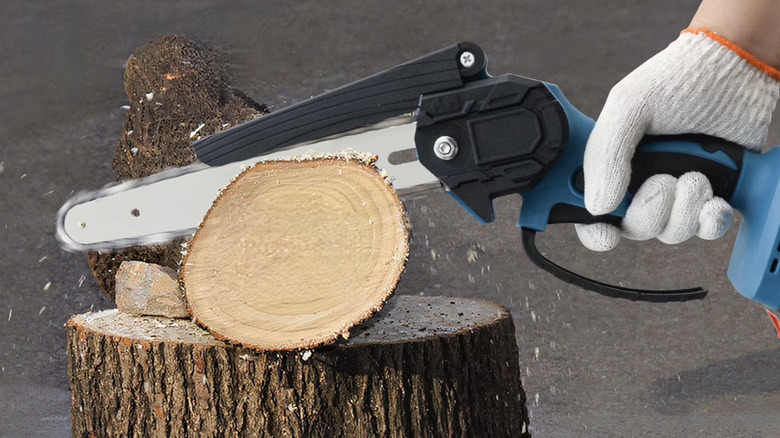Person cutting a tree limb with a mini chainsaw
