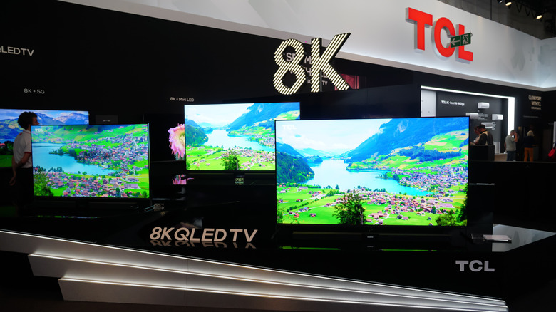 Televisions displayed side by side in an electronics store.