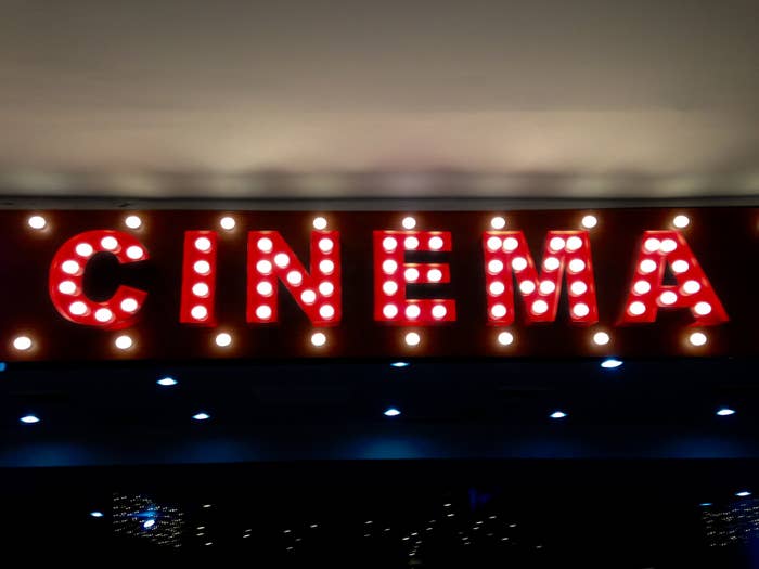 Illuminated "CINEMA" sign with spotlight bulbs, evoking a classic theater ambiance