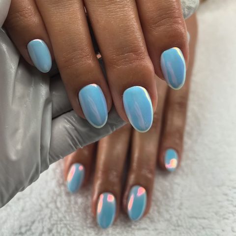Manicured hands with a glossy blue finish on nails
