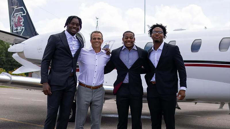 South Carolina coach Shane Beamer (second from left) with Nyck Harbor (left), Peyton Williams and LaNorris Sellers (right) at the airport after arriving for SEC Media Days on July 21 in Tampa, Fla. SEC/Provided