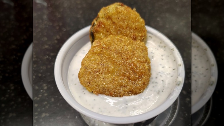 Fried Pickle Chips dipped in buttermilk sauce at Chicken Guy!