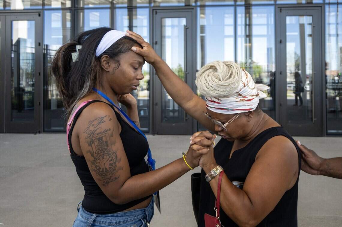 Pastor Nakisha Woods of Keys to Victory Ministry prays with Johntezha Alexander outside the Tani G. Cantil-Sakauye Sacramento County Courthouse in Sacramento after a judge declared a mistrial in the K Street mass shooting trial on Tuesday, July 21, 2026.