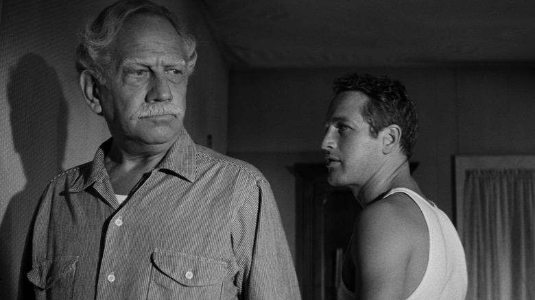 Homer looks forlorn while Hud stands behind him in Hud