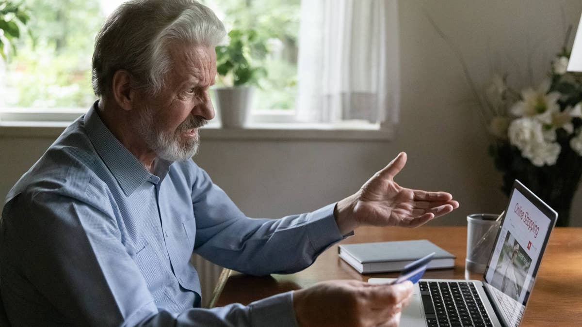 older-man-with-credit-card-and-laptop